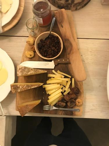 a wooden cutting board with different types of food on it at Cà Virò in Albosaggia