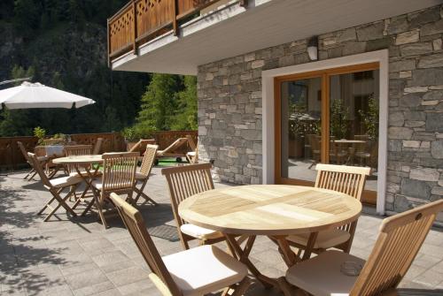 a wooden table and chairs on a patio at Miramonti in Valtournenche