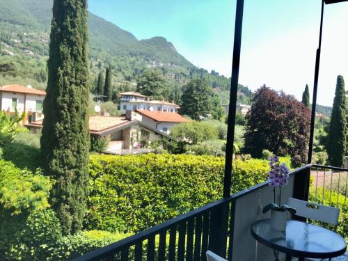 d'un balcon avec une table et une vue sur la montagne. dans l'établissement Residence Villa Alba room nr 415, à Gardone Riviera