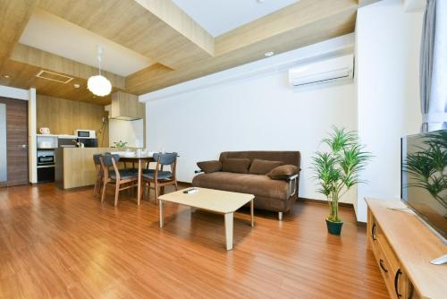 a living room with a couch and a table at Hills Garden Hondori - Vacation STAY 8405 in Sapporo