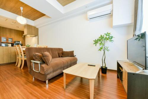 a living room with a couch and a table at Hills Garden Hondori - Vacation STAY 8407 in Sapporo