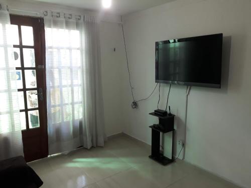 ein Wohnzimmer mit einem Flachbild-TV an der Wand in der Unterkunft Apartamento 3 Bairro Boa Vista 1 Caruaru-PE in Caruaru