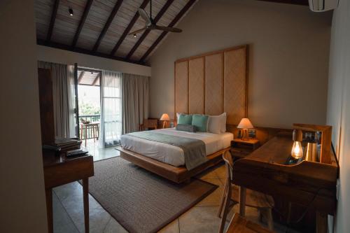 a bedroom with a large bed and a balcony at The Merchant in Galle