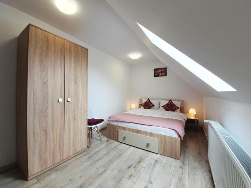 a bedroom with a bed and a wooden cabinet at Mont Melis in Sînpetru