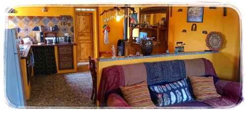 a living room with a couch and a kitchen at Bed and Breakfast Balli coi Lupi in Varzi