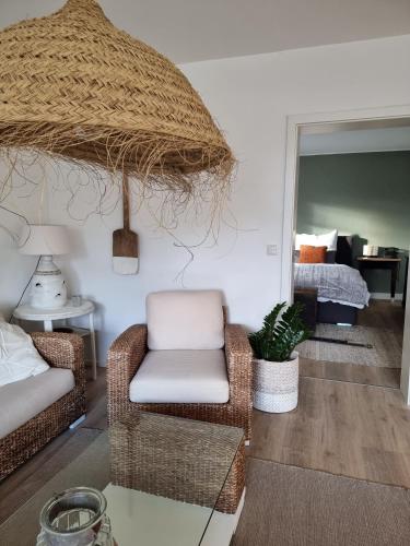 a living room with a chair and a bed at WEINBERG 16 in Elsenfeld