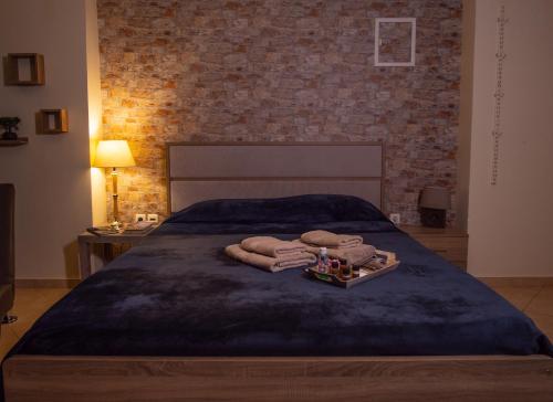 a bedroom with a bed with a tray of towels at Lycurgus - The Spartan Home in Sparti