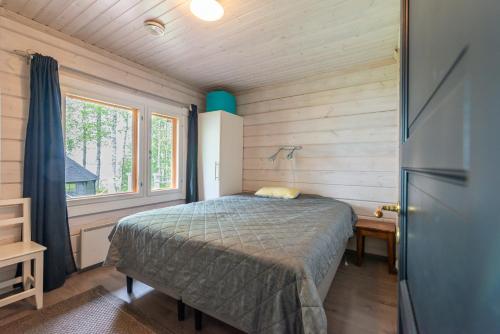 เตียงในห้องที่ Lähderinne - Beachfront 2 bedroom log cabin, private beach & sauna