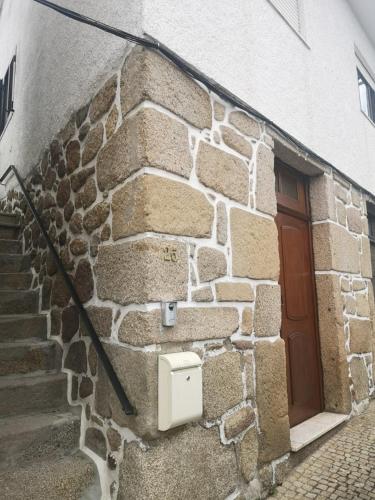 a stone building with a door and a stairs at Casa Girão - Alojamento Local in Termas de Sao Pedro do Sul