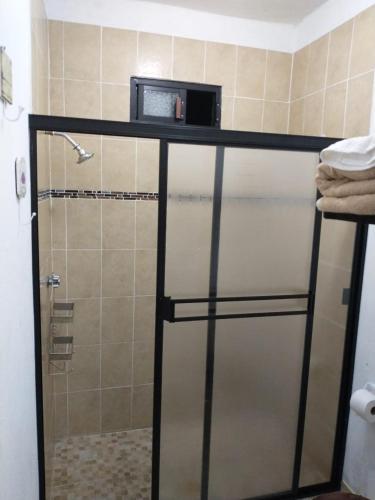 a bathroom with a shower with a microwave at Casa LUNA in La Paz