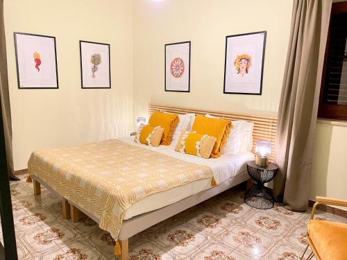a bedroom with a bed with yellow pillows at La Casa Grande di Pantelleria in Pantelleria