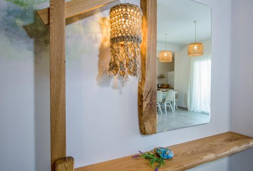 a mirror on a wall next to a dining room at Eleana Nature & Art in Khóra Sfakíon