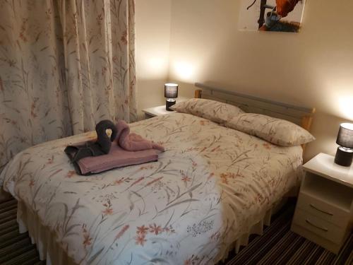 a bedroom with a bed with a stuffed animal on it at Foot of the Mournes - Cottage - Sleeps 4 - Parking in Newry