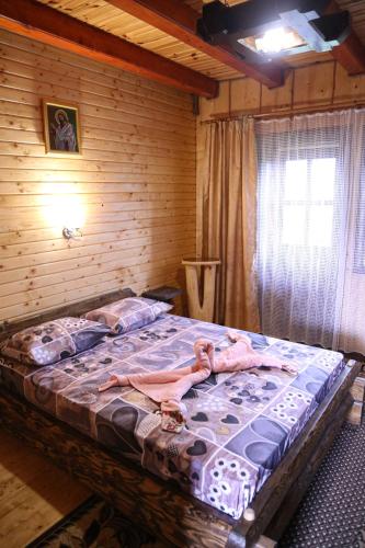 a woman laying on a bed in a room at Верх Довбуша in Vorokhta