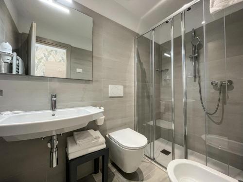 a bathroom with a sink toilet and a shower at Hotel Stella Alpina in Malcesine