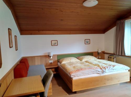 a bedroom with a bed and a wooden ceiling at Haus Kieler in Schladming