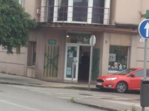 a red car parked in front of a building at Casa Pimen in Gijón