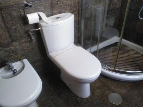 a bathroom with a toilet and a sink and a shower at Casa Pimen in Gijón