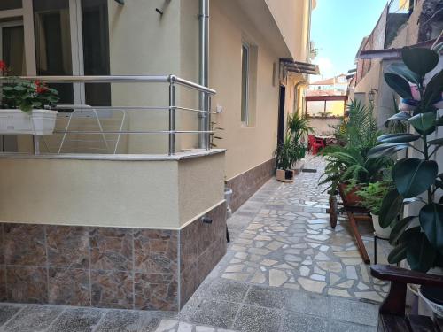 a balcony with plants on the side of a building at Guest Rooms Kostovi in Nesebar