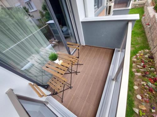 an overhead view of a patio with two chairs and a plant at "The House" Апартаменти и Термална зона in Velingrad