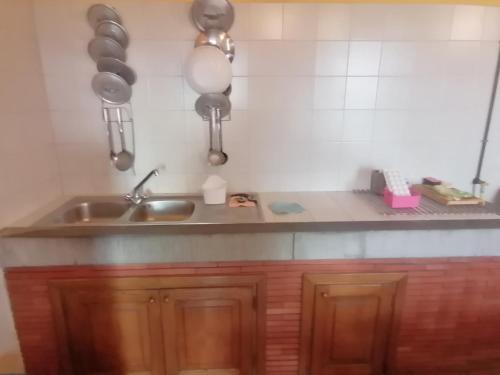 a kitchen with a sink and a counter with utensils at Parco Colle Fobia in Barga