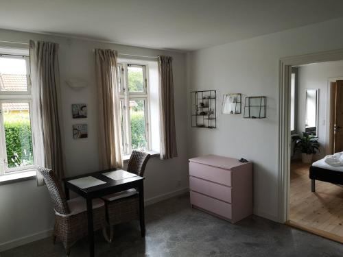 a bedroom with a desk and a bed and a mirror at Safine B&B in Fåborg