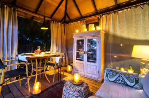 a room with a porch with a table with candles at KiChic in Máncora