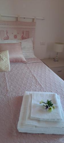 a bed with two towels on top of it at Monte Becco panoramic rooms in Santa Teresa Gallura