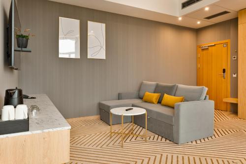 a living room with a couch and a table at Crystal Mountain Hotel Wisła in Wisła