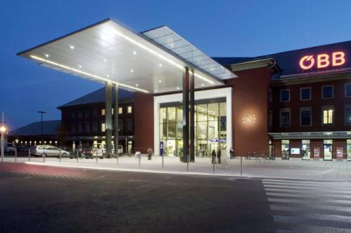 a large building with a lit up facade at night at Villa Lindwurm in Klagenfurt