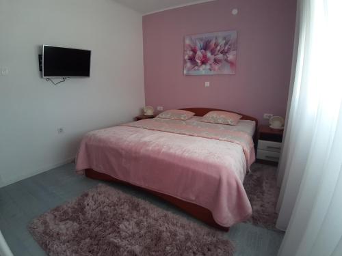 Postel nebo postele na pokoji v ubytování Apartmani Cobanov Josipa
