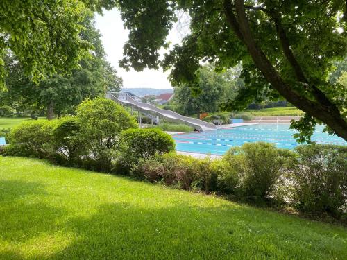 a row of swimming pools in a park at Sali Homes - GaesteHaus Lamm Obersulm in Obersulm