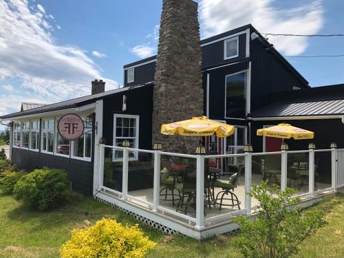 a house with an outdoor patio with two umbrellas at The Iona Heights Inn in Iona