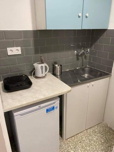 a kitchen with a sink and a counter top at Studios Argyris in Poros