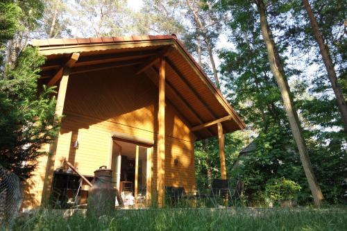 a log cabin with a roof on the side of it at Wald und Wohlsein in Beelitz