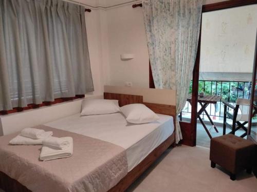 sypialnia z łóżkiem z dwoma ręcznikami w obiekcie Eirini Filippou rooms w mieście Kala Nera