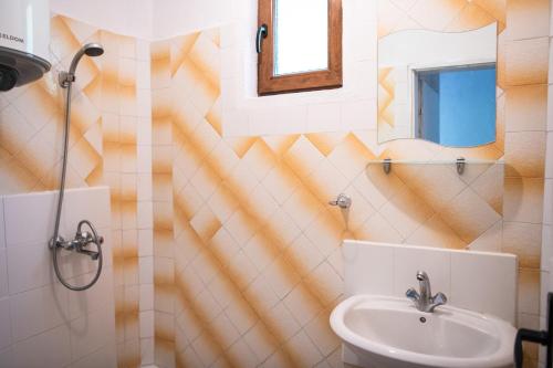 ein Bad mit einem Waschbecken und einem Spiegel in der Unterkunft Къща До Гората Триград in Trigrad