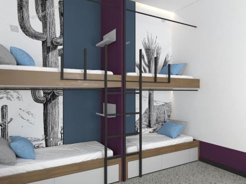 two bunk beds in a room with blue walls at Cocoon City Hostel in Chania