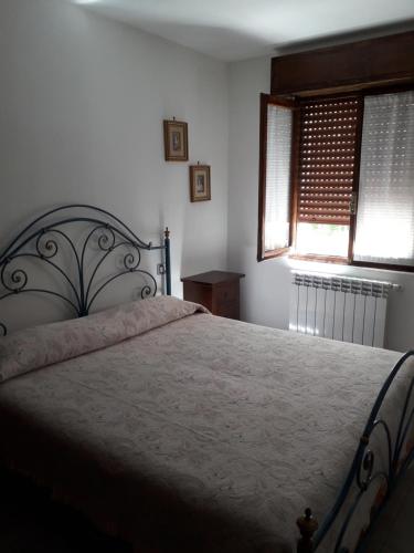 um quarto com uma cama grande e 2 janelas em B&B Let&Lat em Marcheno