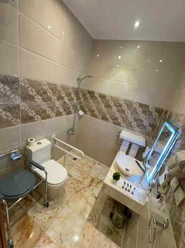 a bathroom with a toilet and a sink at Rose Jeddah Hotel in Jeddah
