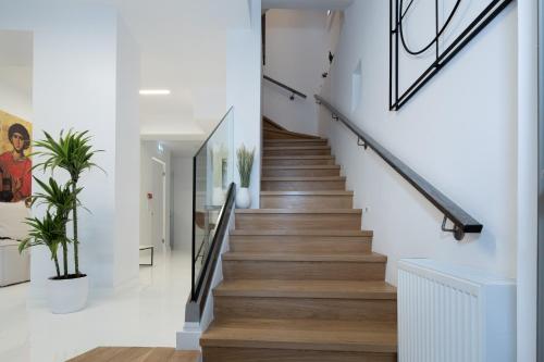 a staircase in a house with white walls and wooden floors at Clock Tower Aparthotel in Arachova