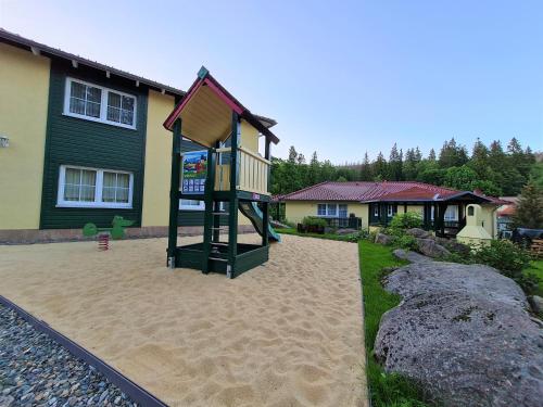 a playground in the backyard of a house at Ferienanlage Zum Wildbach Schierke in Schierke