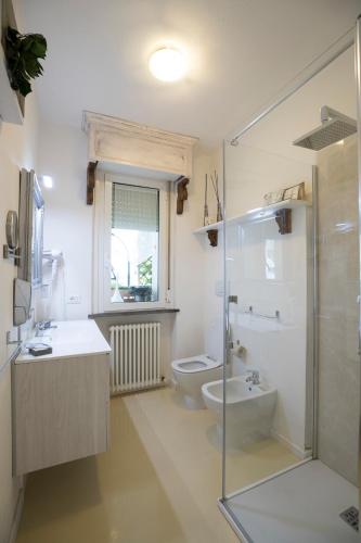 a bathroom with a toilet and a sink and a shower at Come sentirsi a casa in Piacenza