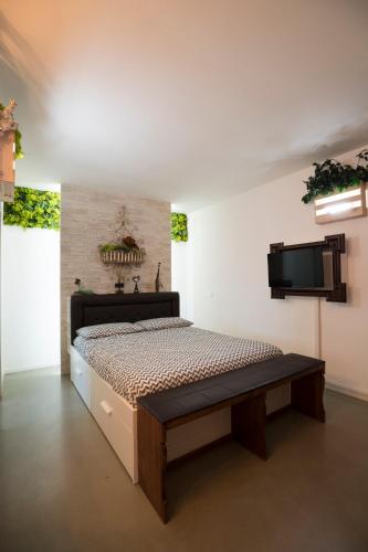a bedroom with a bed and a flat screen tv at Come sentirsi a casa in Piacenza
