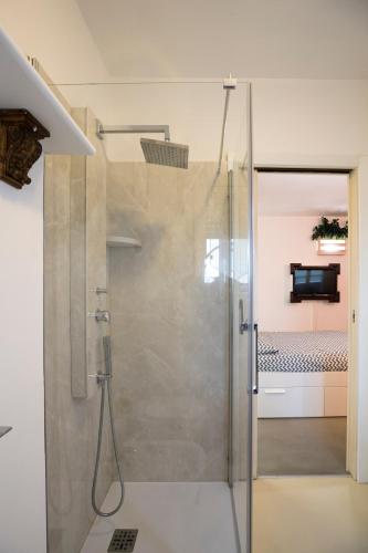 a shower with a glass door in a bathroom at Come sentirsi a casa in Piacenza