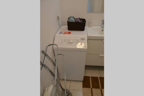 a small kitchen with a white stove and a sink at Spacious Flat Garden&Parking 5min Basel Tram Bus Airport in Saint-Louis