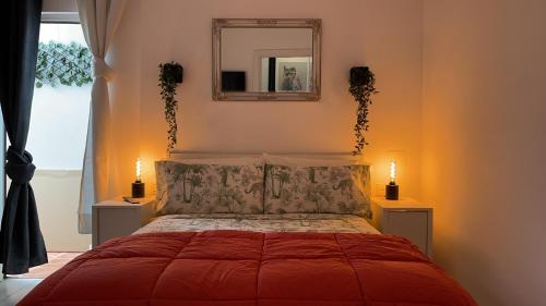 a bedroom with a red bed with a mirror on the wall at Dream Recova in Santa Cruz de Tenerife