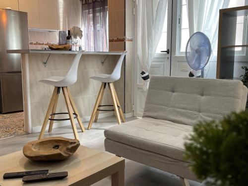 a living room with a couch and two stools at Dream Recova in Santa Cruz de Tenerife