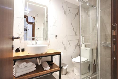 a bathroom with a sink and a toilet at Aethon Airport Project-FREE SHUTTLE by GK Properties in Markopoulo