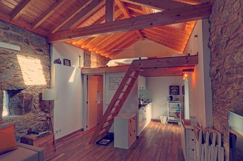 a room with a loft with a ladder in it at I Loft Viana in Viana do Castelo